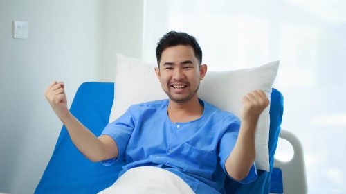 An invigorated patient in hospital dress